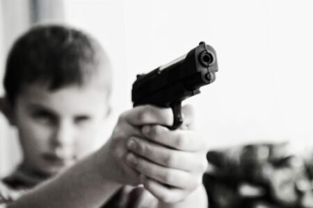 child-holding-a-gun-point-stockpack-pixabay-scaled